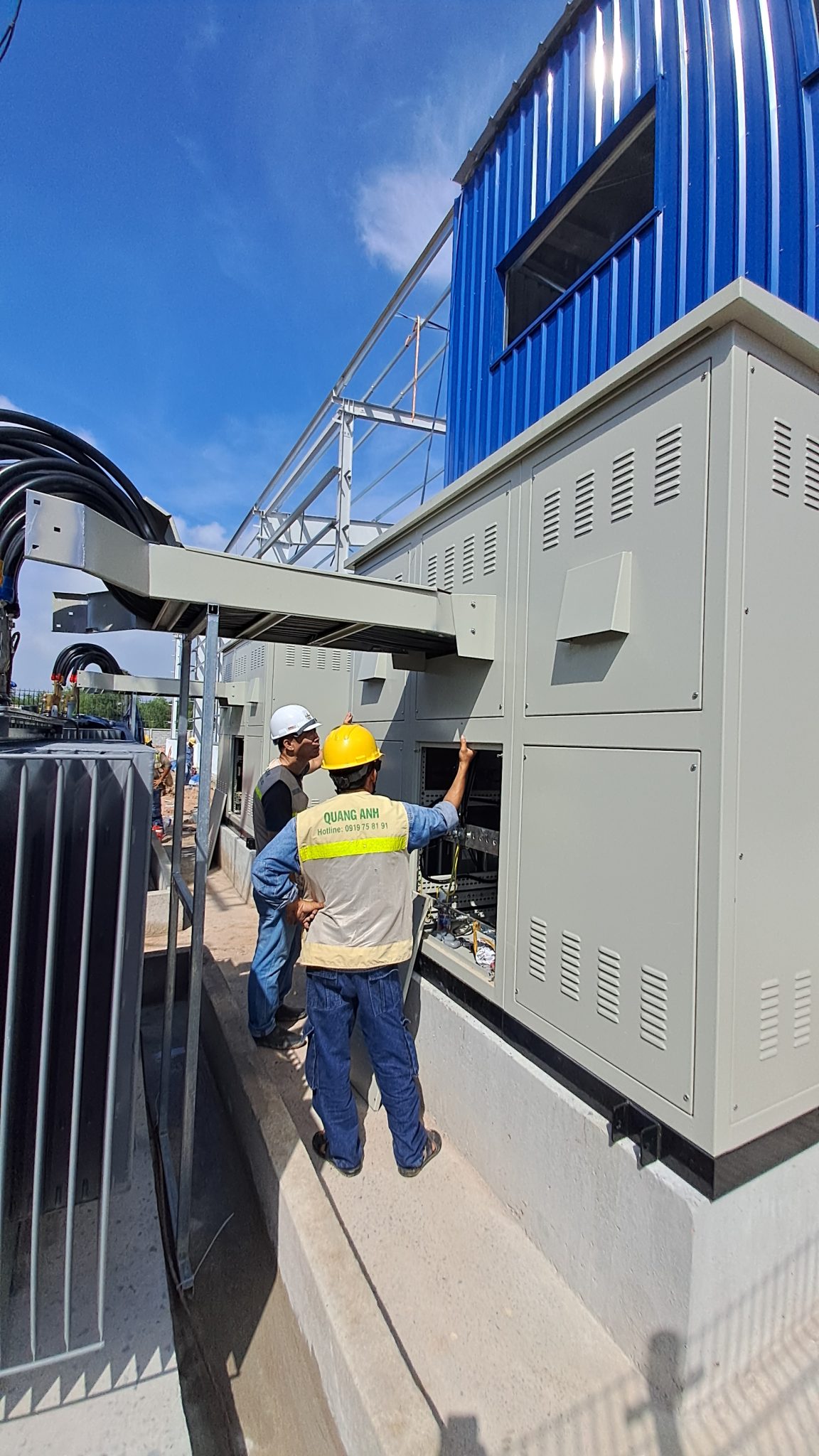 QuangAnhcons Services and Technical Processes. Engineer working on an industrial plant's electrical system.