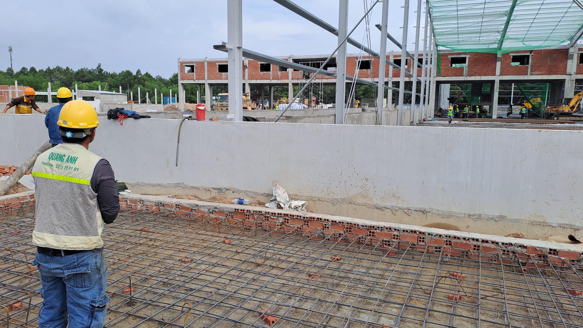 Diverse Operations of QuangAnhcons. Technicians installing electrical systems in a modern industrial building.