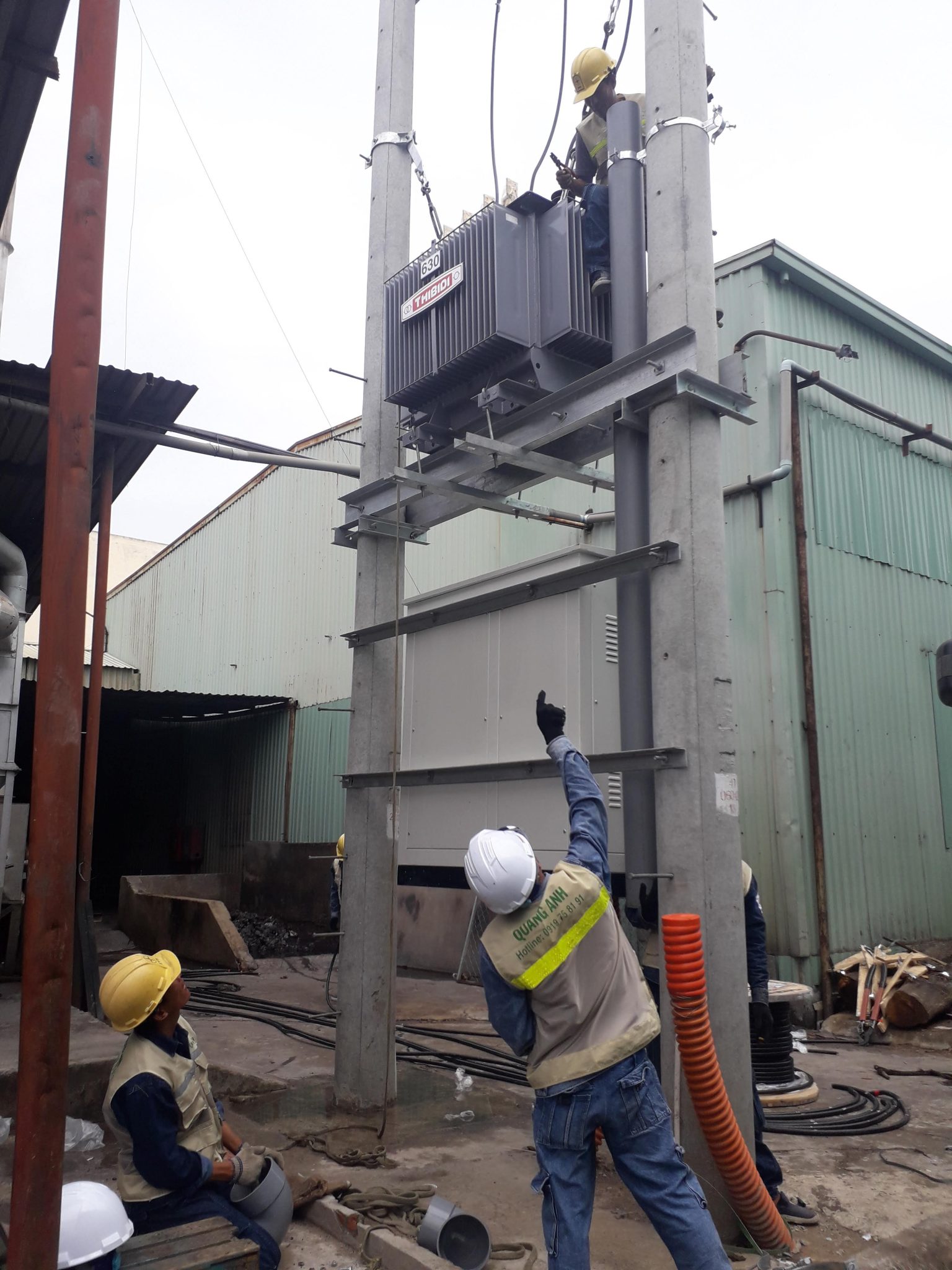 Engineers consulting at an industrial electrical site.