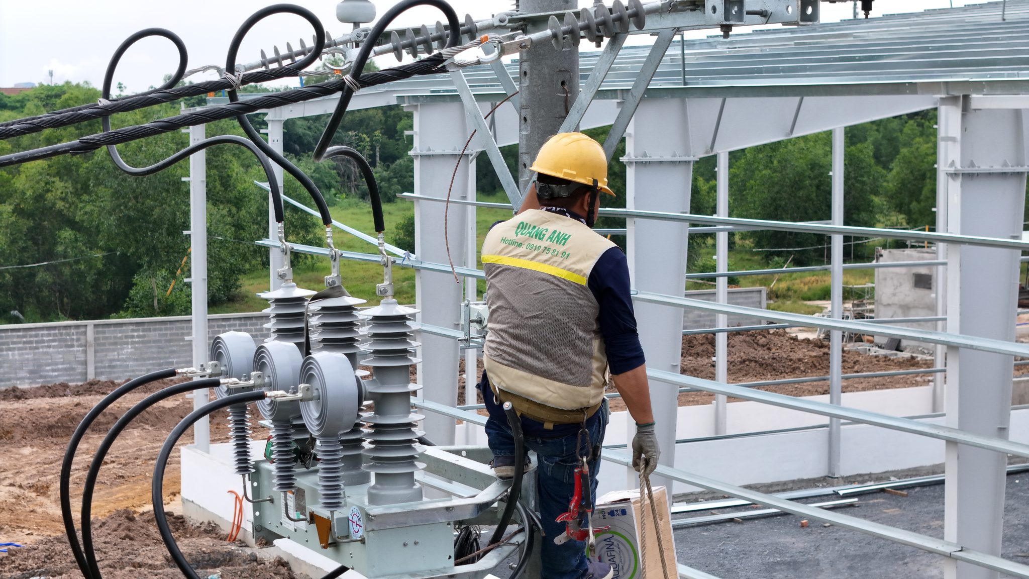 Team of QuangAnhcons engineers installing an EV charging station.