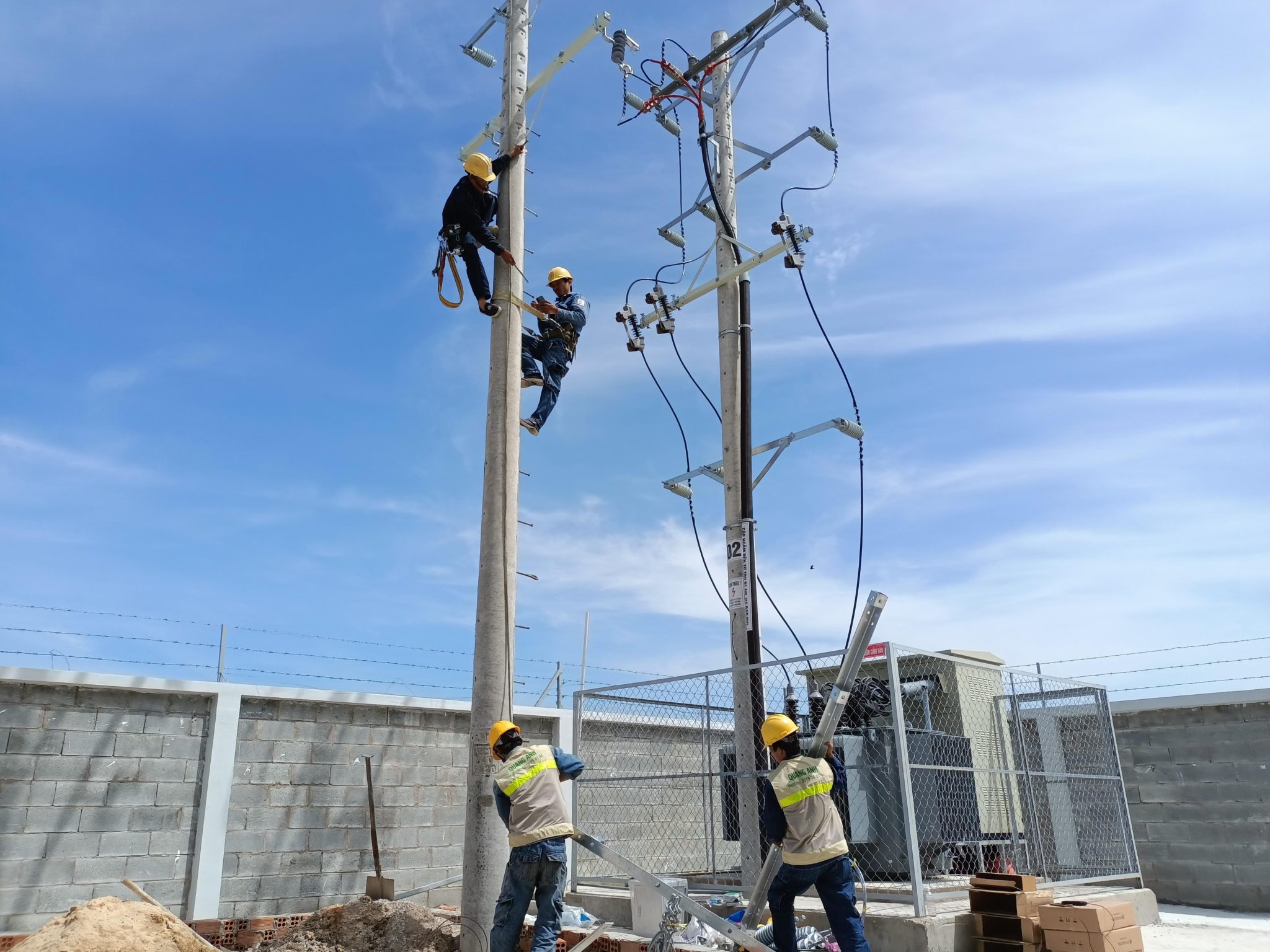 Engineers and workers at electrical construction site.