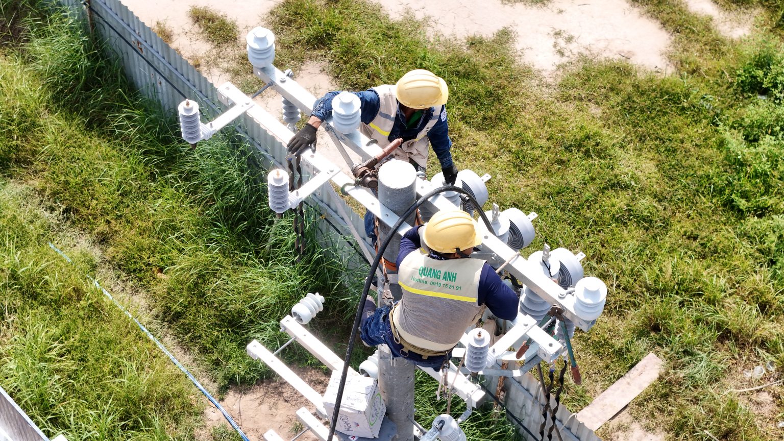 QuangAnhcons technicians working around outdoor electrical switching equipment