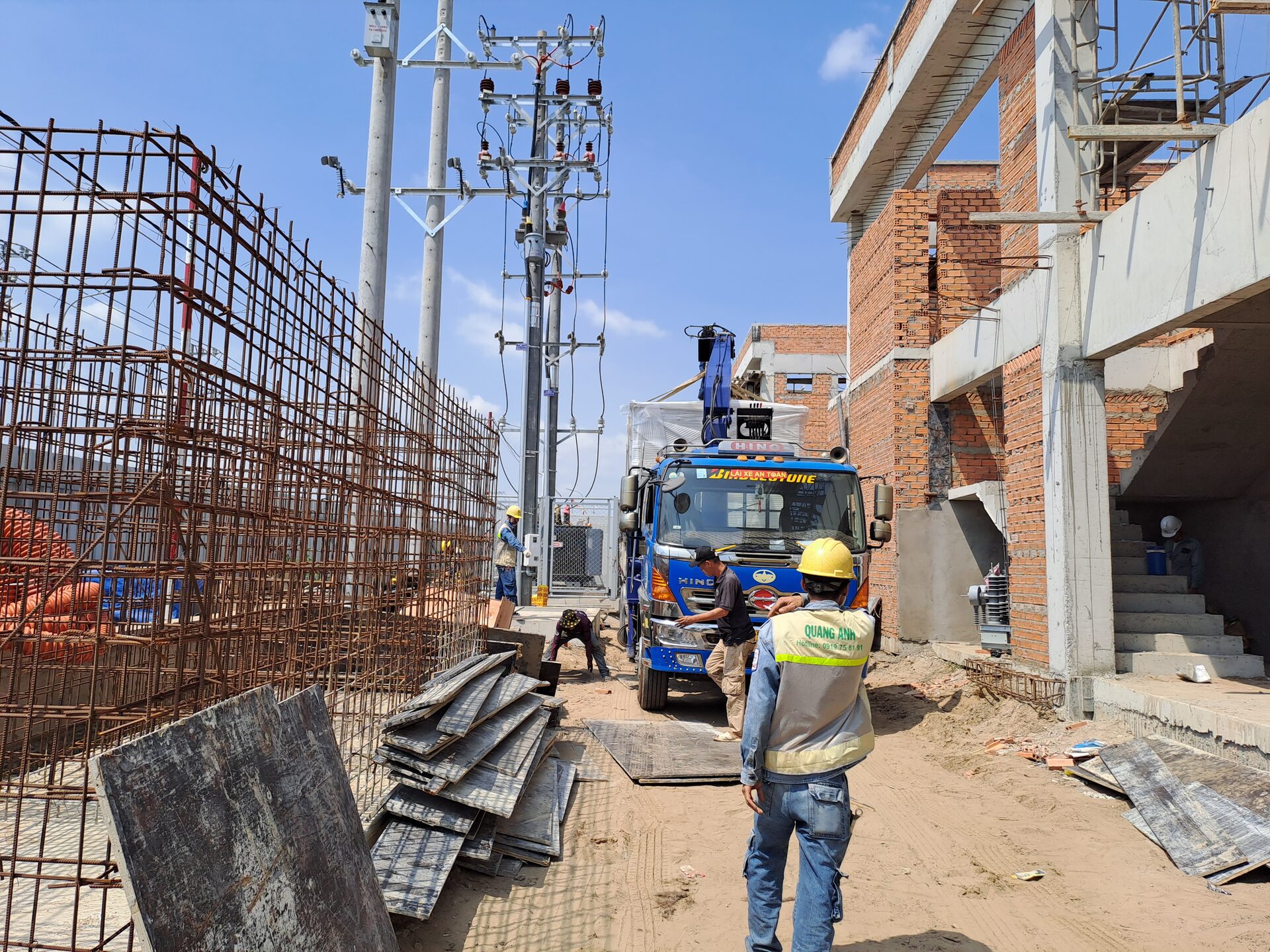QuangAnhcons archive showing an electrical equipment delivery vehicle and a construction access lane