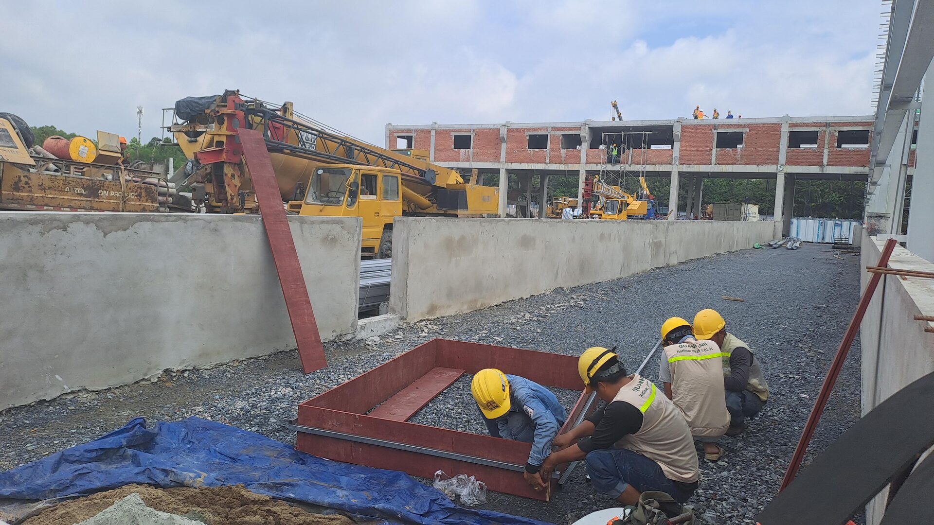 QuangAnhcons archive showing a steel base frame being assembled at ground level