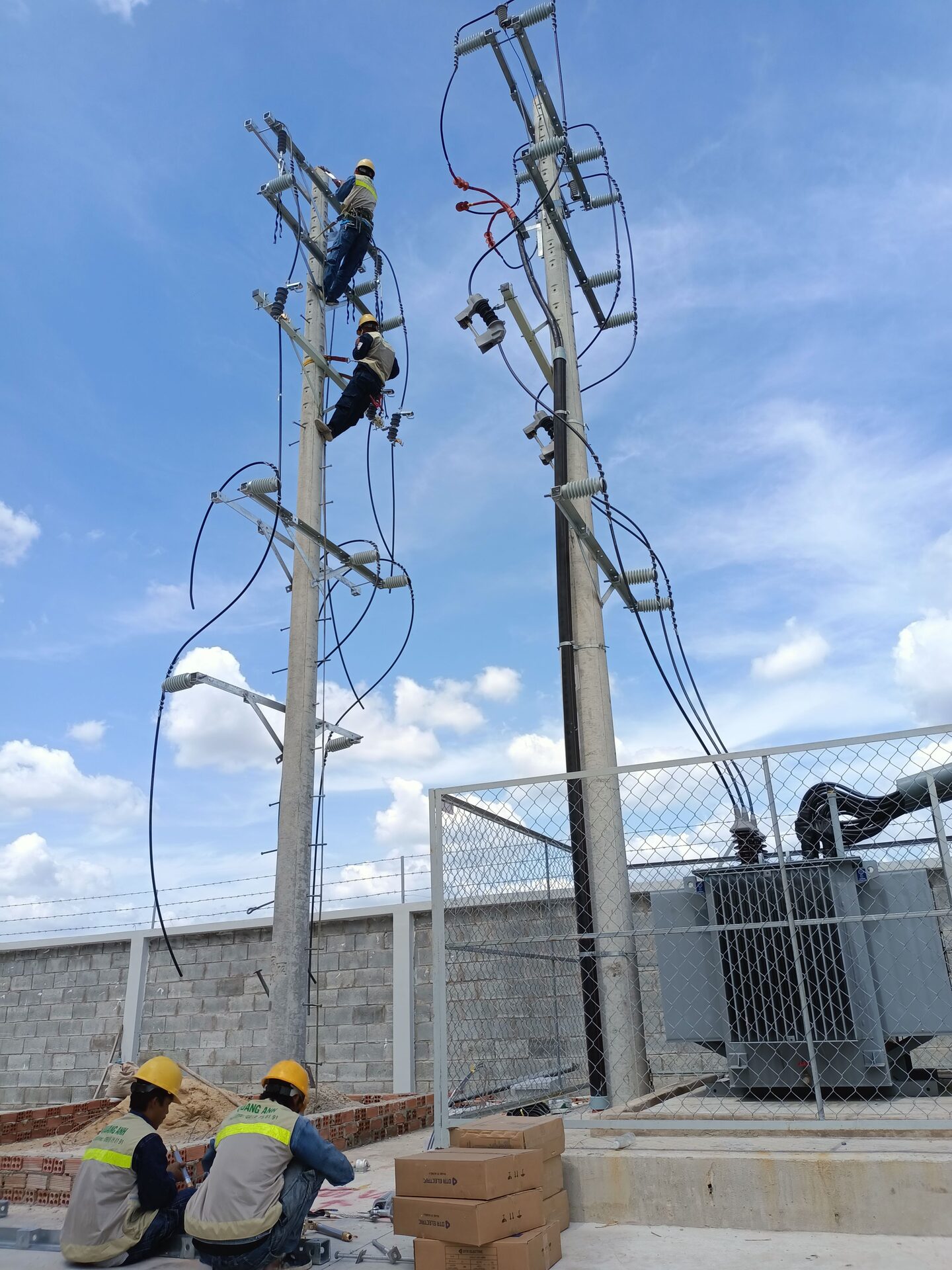 QuangAnhcons archive showing overhead electrical infrastructure and a transformer enclosure