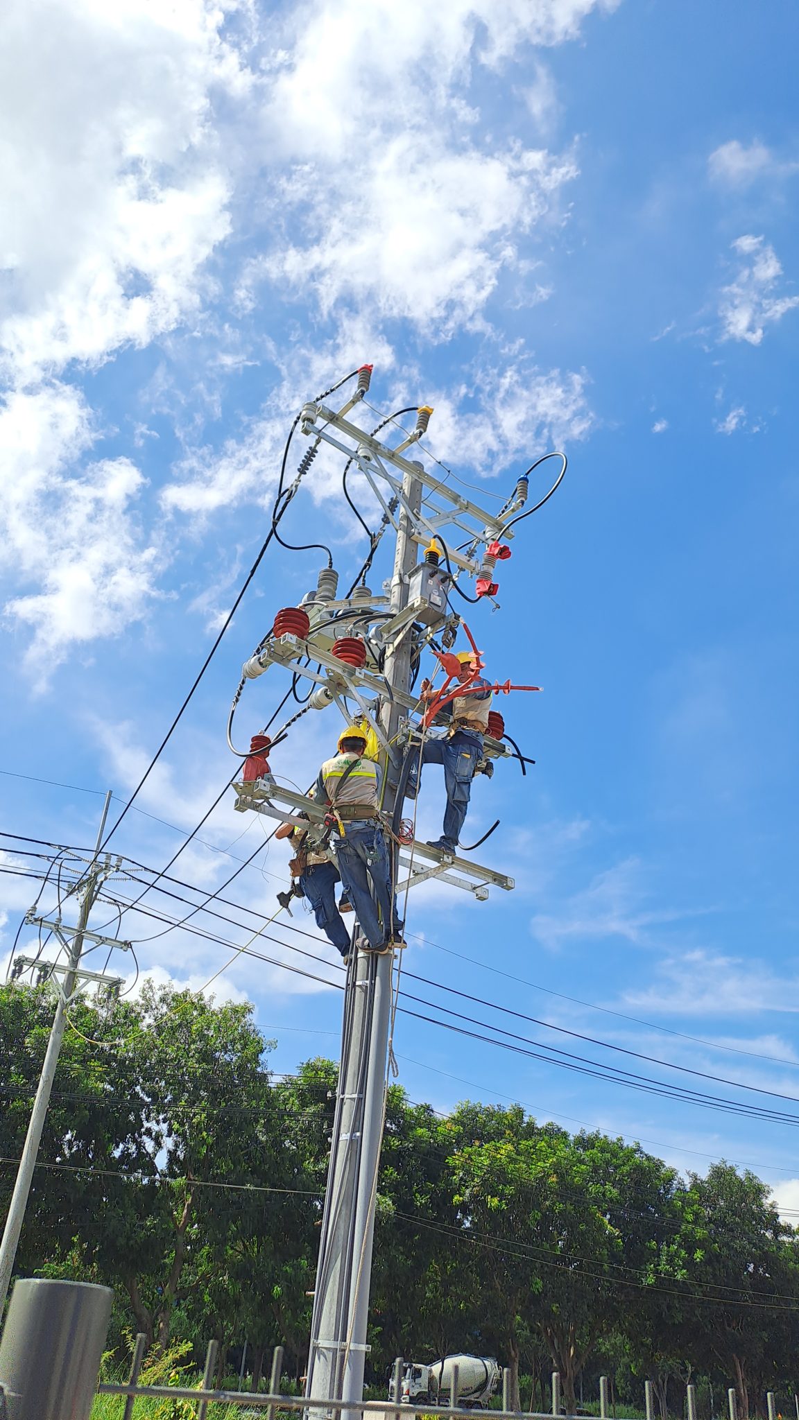 Workers inspecting and maintaining electrical systems.
